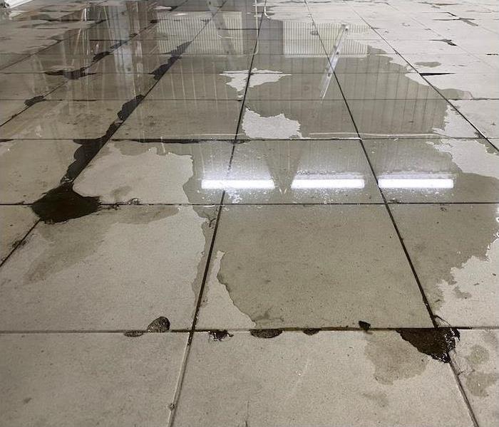 concrete tile floor covered with water