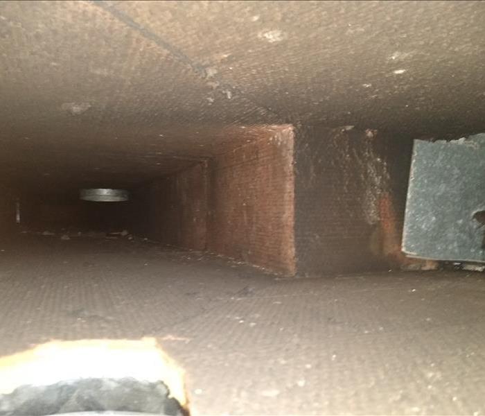 Interior of HVAC ductwork that has been affected by soot