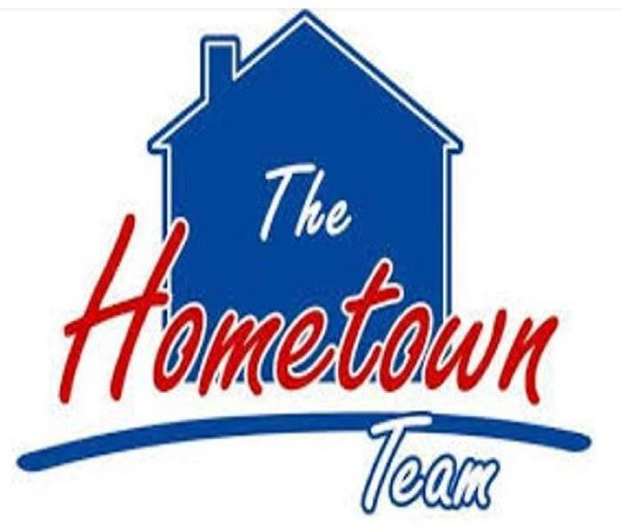 Logo, silhouette of a house with "the hometown team" written in front.