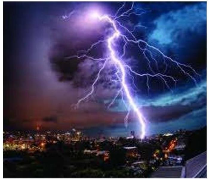 lightning in a dark sky over a city