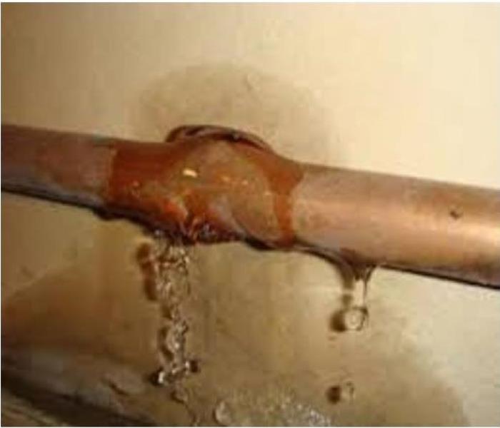 copper pipe cracked and leaking water onto drywall